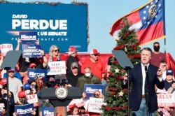 Georgia Sen. David Perdue speaks during a runoff campaign rally with Vice President Mike Pence, Dec. 10, 2020, in Augusta, Georgia.