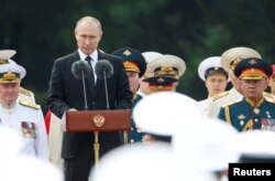 Russian President Vladimir Putin delivers a speech during the Navy Day parade in St. Petersburg, Russia, July 30, 2017.