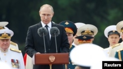 Russian President Vladimir Putin delivers a speech during the Navy Day parade in St. Petersburg, Russia, July 30, 2017. 