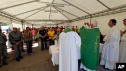  The bishop of Ascoli Piceno, Giovanni D'Ercole, celebrates mass in a tent camp set in Pescara del Tronto, near Amatrice, central Italy, Aug. 28, 2016. 