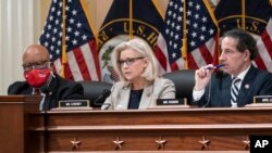 Rep. Liz Cheney, R-Wyo., vice chair of the House panel investigating the Jan. 6 U.S. Capitol insurrection, is flanked by Chairman Bennie Thompson, D-Miss., left, and Rep. Jamie Raskin, D-Md., as they vote on pursuing contempt charges against Mark Meadows.