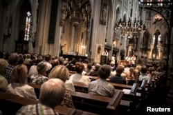 St. Jan Cathedral is filled with people attending the evening vigil for those who were killed in the Malaysia Airlines Flight MH17 plane crash, in Den Bosch, Netherlands, July 19, 2014.