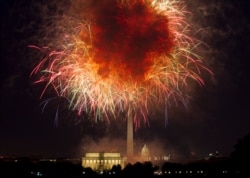 In this July 4, 2018, photo, fireworks explode over Lincoln Memorial, Washington Monument and U.S. Capitol, along the National Mall in Washington, during the Fourth of July celebration.