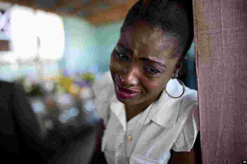 A woman cries near the coffin containing the body of a relative who died at the country&#39;s largest prison in Port-au-Prince, Haiti, Feb. 21, 2017. Relatives wailed in grief as flowers were placed on 20 caskets at a mass funeral for the latest group of inmates who died miserably in Haiti&#39;s largest prison, most without ever having been convicted of any crime.
