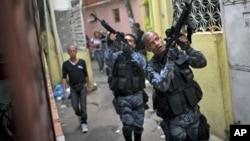 FILE - Military police officers patrol in the Roquette Pinto shantytown, part of the Mare slum complex in Rio de Janeiro, Brazil, April 1, 2015. 