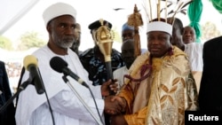 FILE - Kwire-Mana (R), receives his staff of office from Adamawa State Governor Murtala Nyako during a presentation ceremony at Makwada Square in Numan, Adamawa state, Dec. 7, 2013. 