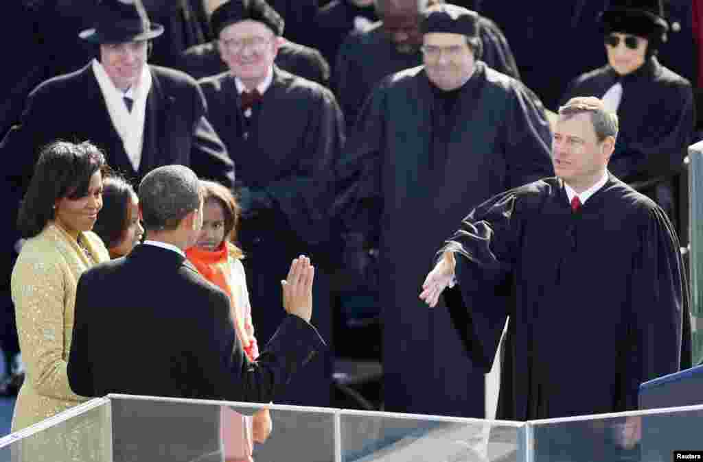 Barack Obama takes the Oath of Office as the 44th President of the United States as he is sworn in by U.S. Chief Justice John Roberts (R) during the inauguration ceremony in Washington, January 20, 2009.