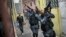 FILE - Military police officers patrol in the Roquette Pinto shantytown, part of the Mare slum complex in Rio de Janeiro, Brazil, April 1, 2015. 