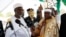 FILE - Kwire-Mana (R), receives his staff of office from Adamawa State Governor Murtala Nyako during a presentation ceremony at Makwada Square in Numan, Adamawa state, Dec. 7, 2013. 