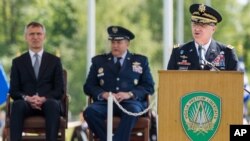 New NATO's Supreme Allied Commander Europe, U.S. Army General Curtis M. Scaparrotti delivers a speech as NATO Secretary-General Jens Stoltenberg, left, and former NATO's Allied Commander Europe U.S. General Philip M. Breedlove listen during a change of command ceremony at NATO military headquarters in Mons, Belgium, May 4, 2016. 