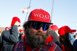 FILE - A man wearing a cap that references the QAnon slogan attends a Trump campaign rally in Butler, Pennsylvania, Oct. 31, 2020.