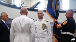 Secretary of Defense Jim Mattis, left, U.S. Navy Adm. Kurt Tidd, center left, U.S. Navy Adm. Craig Faller, center right, stand during a change of command ceremony at the U.S. Southern Command headquarters, Nov. 26, 2018, in Doral, Florida. 