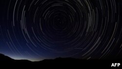 A multiple exposure picture taken in the early hours of August 11, 2013 shows a Perseids meteor shower in the sky, near the municipality of La Hiruela, on the mountains of the Sierra Norte de Madrid.