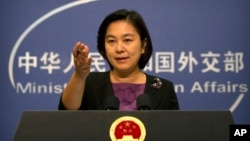 FILE - Chinese foreign ministry spokeswoman Hua Chunying gestures during a press briefing at the Ministry of Foreign Affairs building in Beijing.