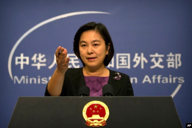 FILE - Chinese foreign ministry spokeswoman Hua Chunying gestures during a press briefing at the Ministry of Foreign Affairs building in Beijing.