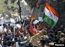 Activists from various Hindu right-wing groups shout slogans as they try to cross a police barricade during a protest against the students of Jawaharlal Nehru University outside the university campus in New Delhi, India, Feb. 16, 2016.