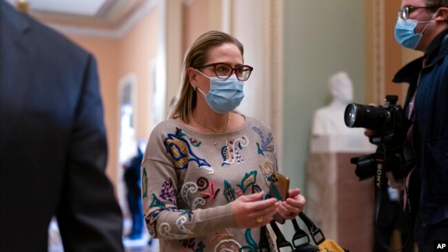 Sen. Kyrsten Sinema, D-Ariz., walks to the chamber after a Senate Democratic Caucus meeting at the Capitol in Washington, Nov. 2, 2021. Sinema, a key holdout on President Joe Biden's social agenda, reached a deal with Senate Majority Leader Chuck Schumer on a plan to lower prescription drug costs for older people, capping out-of-pocket Medicare costs at $2,000 and reducing the price of insulin.