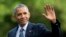 FILE - President Barack Obama waves as he walks across the South Lawn of the White House, in Washington.