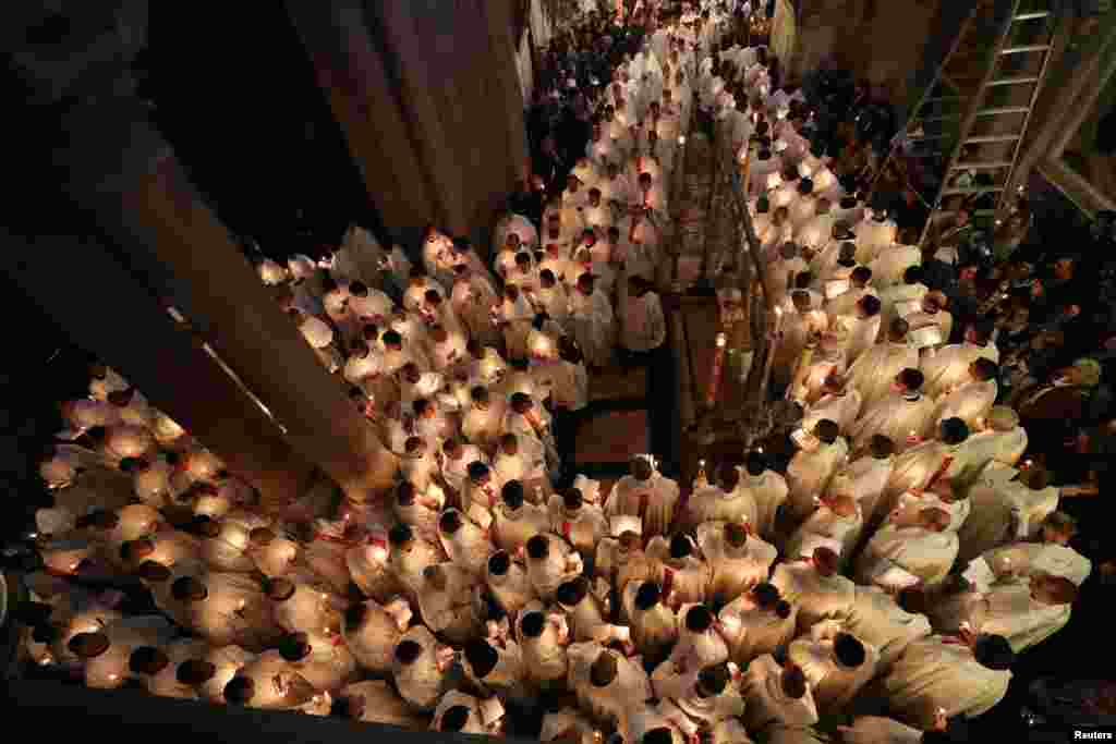 Worshippers take part in a procession during the Catholic Washing of the Feet ceremony on Easter Holy Week in the Church of the Holy Sepulchre in Jerusalem's Old City.