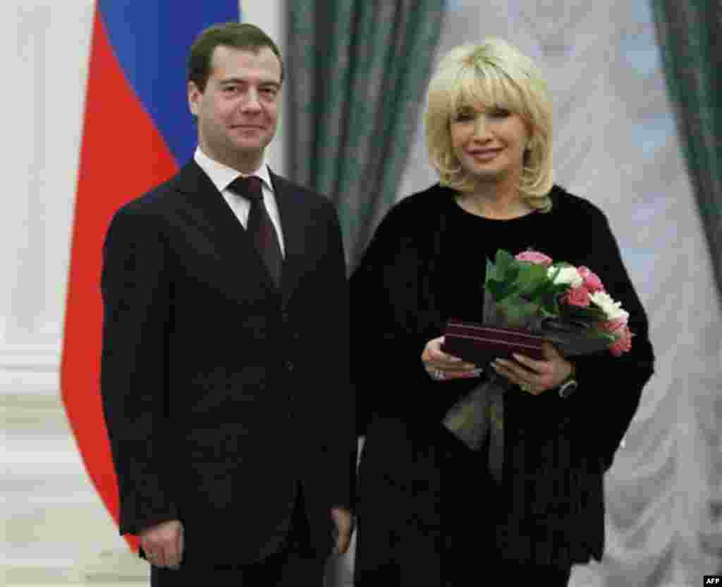 Russian President Dmitry Medvedev awards Russian pop singer Irina Allegrova with the title of People's Artist during an award ceremony in the Kremlin in Moscow, Thursday, Dec. 30, 2010. (AP Photo/RIA Novosti, Dmitry Astakhov, Presidential Press Service)