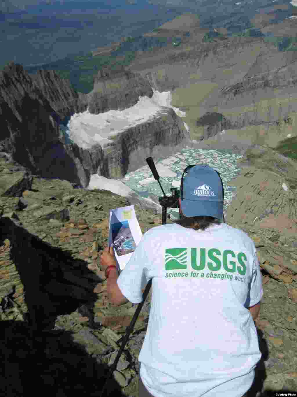  A USGS scientist shoots a repeat photograph of Grinnell Glacier in Glacier National Park to illustrate glacial recession due to impacts of climate change. (Lisa McKeon, Northern Rocky Mountain Science Center) 