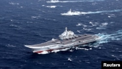 China's Liaoning aircraft carrier with accompanying fleet conducts a drill in an area of South China Sea, in this undated photo taken December 2016. 