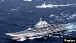 China's Liaoning aircraft carrier with accompanying fleet conducts a drill in an area of South China Sea, in this undated photo taken December 2016. 