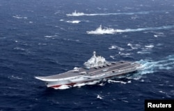 FILE - China's Liaoning aircraft carrier with accompanying fleet conducts a drill in an area of South China Sea, in this undated photo taken December 2016.