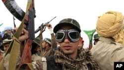 A Libyan government soldier poses for the camera at the west gate of town Ajdabiyah, March 17, 2011