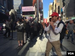 Tony, who came to the U.S. specifically for Election Day, is visiting from Melbourne, Australia, and talks about the candidates, in Times Square, New York, Nov. 8, 2016. (R. Taylor/VOA)