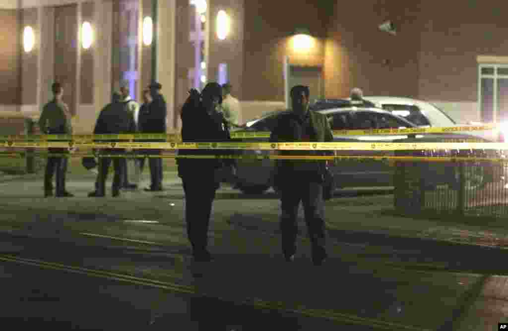 Police gather outside the Ferguson Police Department after two police officers were shot according to witnesses in Ferguson, Mo.