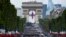 Troops wait near the Arc de Triomphe, in Paris, France, before taking part in the annual Bastille Day military parade on the Champs-Elysees avenue.
