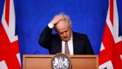 Britain's Prime Minister Boris Johnson gestures as he speaks during a press conference in London, Nov. 27, 2021, after cases of the new COVID-19 variant were confirmed in the UK.