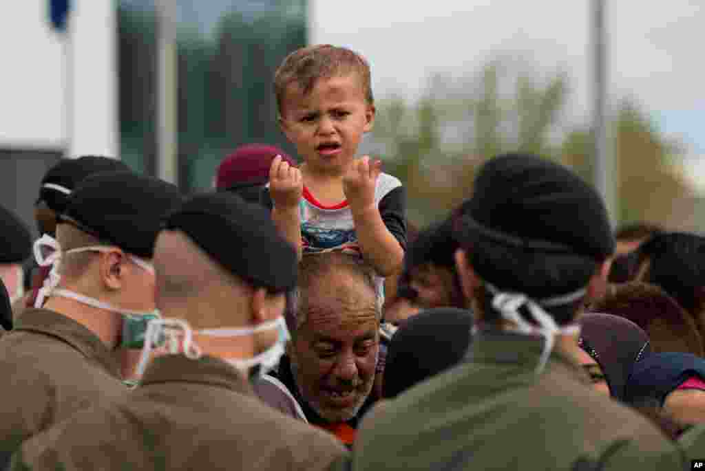 Migrants waiting for busses at the border between Austria and Hungary.