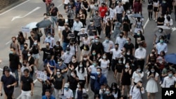 Protesters march during a flash mob protest in Hong Kong, on Friday, Oct. 11, 2019. Hundreds of masked protesters gathered at Chater Garden in central Hong Kong on Friday to rally against police brutality and show their support for students who have…
