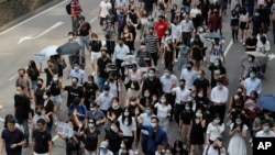 Protesters march during a flash mob protest in Hong Kong, Oct. 11, 2019.