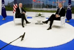 NATO Secretary General Jens Stoltenberg speaks with U.S. President Joe Biden during a bilateral meeting on the sidelines of a NATO summit at NATO headquarters in Brussels, June 14, 2021.