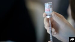 FILE: A worker readies syringes with the Moderna COVID-19 vaccine in Metairie, Los Angeles, March 29, 2021.