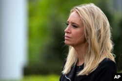 White House press secretary Kayleigh McEnany listens as lawmakers talk about the coronavirus spending bill after meeting with President Donald Trump at White House, April 21, 2020, in Washington.