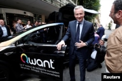 French Finance Minister Bruno Le Maire poses as he visits the new headquarters of search engine Qwant in Paris, June 14, 2018.