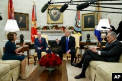 FILE - House Minority Leader Rep. Nancy Pelosi, D-Calif., Vice President Mike Pence, President Donald Trump, and Senate Minority Leader Chuck Schumer, D-N.Y., meet in the Oval Office of the White House, Dec. 11, 2018.