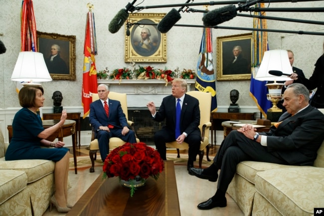 FILE - House Minority Leader Rep. Nancy Pelosi, D-Calif., Vice President Mike Pence, President Donald Trump, and Senate Minority Leader Chuck Schumer, D-N.Y., meet in the Oval Office of the White House, Dec. 11, 2018.