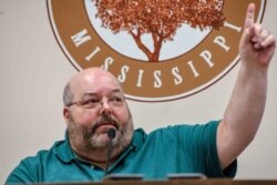 Petal Mayor Hal Marx raises his hand and refuses to resign at a special board of aldermen meeting at Petal City Hall, May 28, 2020, in Petal, Miss., over comments he made about the death of Minneapolis man George Floyd at the hands of police.
