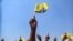 FILE - A supporter of Zimbabwe's main opposition leader and leader of Citizens Coalition for Change (CCC), Nelson Chamisa waves a flag during the party's final rally ahead of the elections in Harare, Zimbabwe, August 21, 2023.