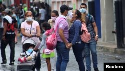  People wear face masks near the Venezuelan-Colombia border.