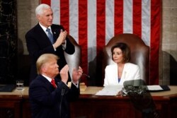 Vice President Mike Pence applauds as President Trump delivers his State of the Union address to a joint session of Congress in Washington, Feb. 4, 2020.