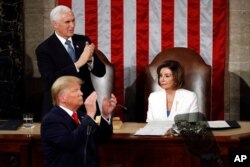 Vice President Mike Pence applauds as President Trump delivers his State of the Union address to a joint session of Congress in Washington, Feb. 4, 2020.