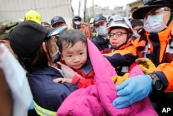 A baby boy is rescued from a collapsed building after an earthquake in Tainan, Taiwan, Feb. 6, 2016.
