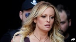 FILE - Adult film actress Stormy Daniels arrives for the opening of an adult entertainment fair in Berlin, Oct. 11, 2018.