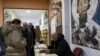 People wait in line during a parliamentary election at a polling station in the northern Serb-dominated part of ethnically divided town of Mitrovica, Kosovo, Feb. 9, 2025.